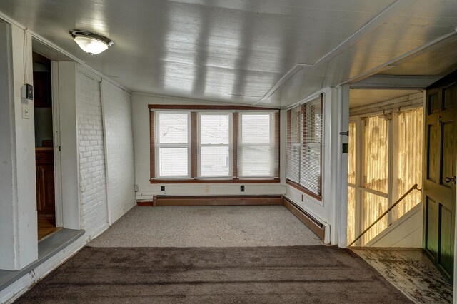 unfurnished sunroom with a baseboard heating unit