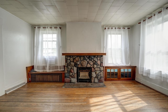 49 S W St, Versailles, OH 45380 - living area with wood finished floors, baseboards, and a fireplace