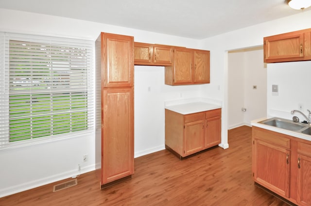 350 N Pleasant Valley Ave, Dayton, OH 45404 - kitchen featuring a sink, light wood-type flooring, light countertops, and baseboards
