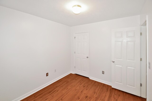 350 N Pleasant Valley Ave, Dayton, OH 45404 - unfurnished bedroom featuring wood finished floors and baseboards