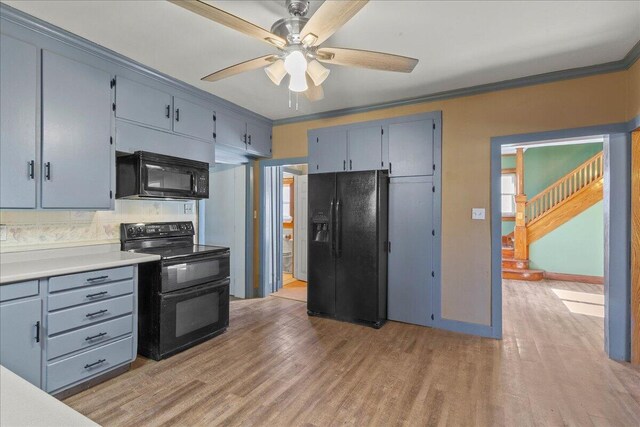 424 N Market St, Kenton, OH 43326 - kitchen with light wood finished floors, a ceiling fan, black appliances, and crown molding