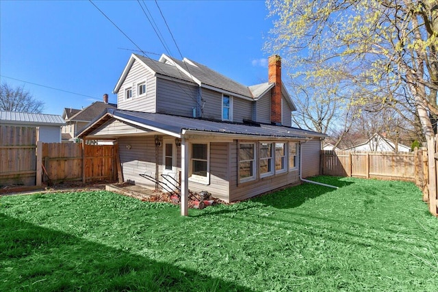 424 N Market St, Kenton, OH 43326 - rear view of property featuring a yard, a chimney, and a fenced backyard