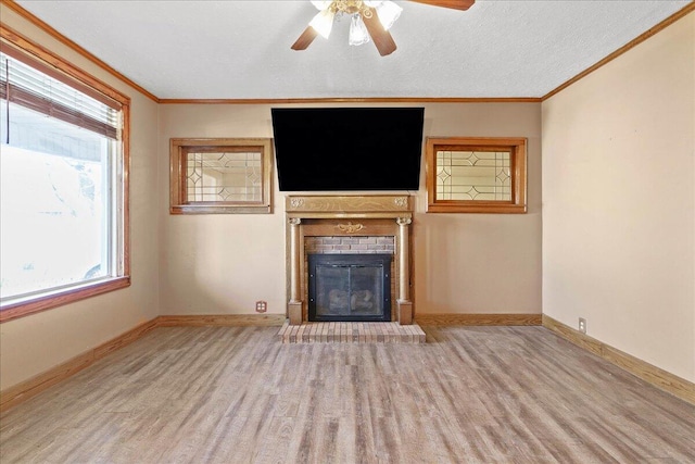 424 N Market St, Kenton, OH 43326 - unfurnished living room with plenty of natural light, a ceiling fan, wood finished floors, and a fireplace