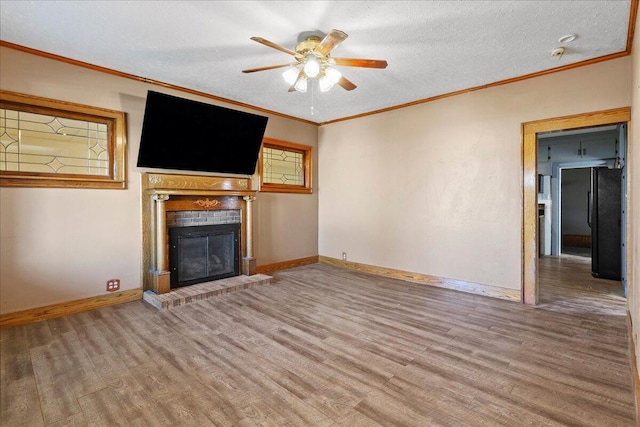 424 N Market St, Kenton, OH 43326 - unfurnished living room with baseboards, a brick fireplace, wood finished floors, and ceiling fan