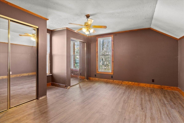 424 N Market St, Kenton, OH 43326 - unfurnished bedroom featuring baseboards, vaulted ceiling, and wood finished floors