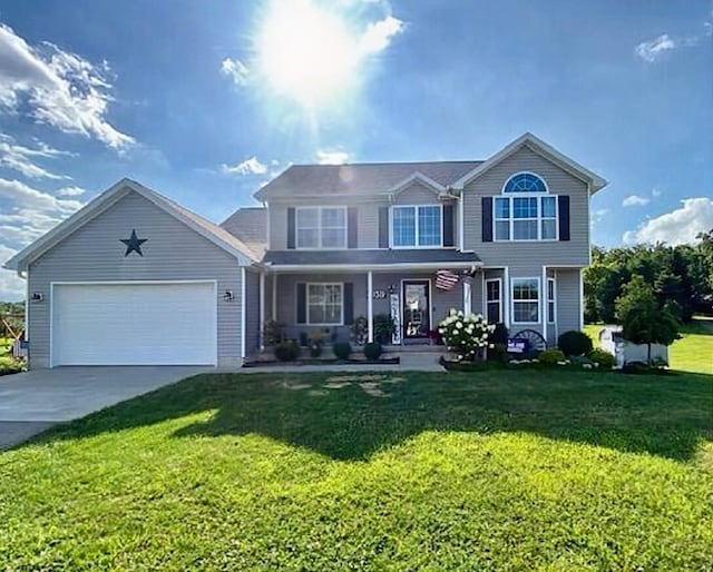 view of front of house with a porch, an attached garage, driveway, and a front yard