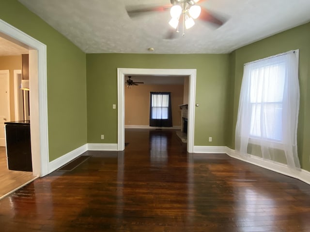 1208 Broadway St, Springfield, OH 45504 - unfurnished room with ceiling fan, wood-type flooring, and a fireplace with raised hearth