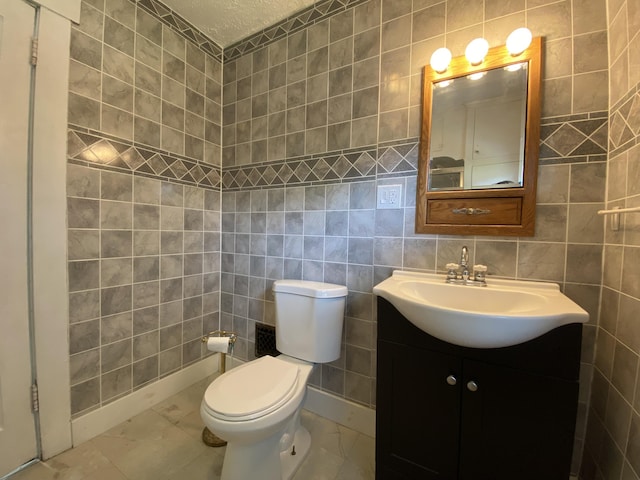 1208 Broadway St, Springfield, OH 45504 - bathroom with vanity, tile walls, and marble look tiles