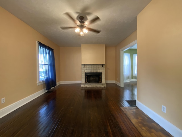 1208 Broadway St, Springfield, OH 45504 - unfurnished living room featuring ceiling fan, dark wood-style floors, and a fireplace