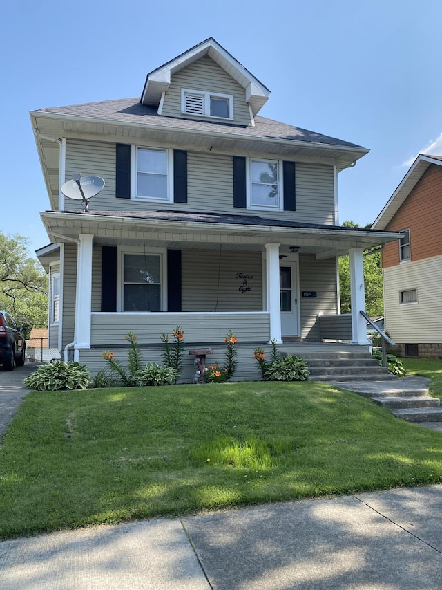 1208 Broadway St, Springfield, OH 45504 - american foursquare style home featuring a porch and a front lawn