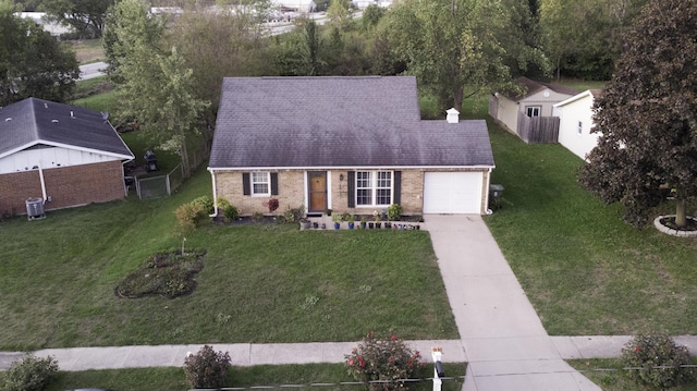 new england style home featuring concrete driveway, brick siding, and a front lawn