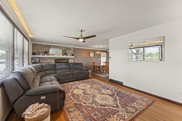 5899 N Springcreek Stringtown Rd, Piqua, OH 45356 - living area with a ceiling fan, wood finished floors, and a stone fireplace