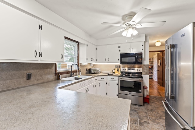 5899 N Springcreek Stringtown Rd, Piqua, OH 45356 - kitchen with stainless steel appliances, ceiling fan, white cabinetry, backsplash, and light countertops