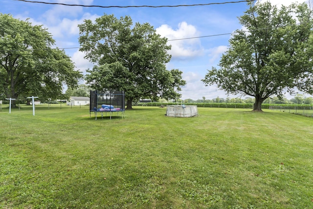 5899 N Springcreek Stringtown Rd, Piqua, OH 45356 - view of yard with a trampoline and an outdoor pool