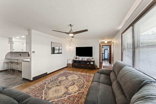 5899 N Springcreek Stringtown Rd, Piqua, OH 45356 - living area with dark wood-style floors, a ceiling fan, and a textured ceiling
