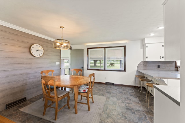 5899 N Springcreek Stringtown Rd, Piqua, OH 45356 - dining room with stone finish flooring, a chandelier, recessed lighting, and wooden walls