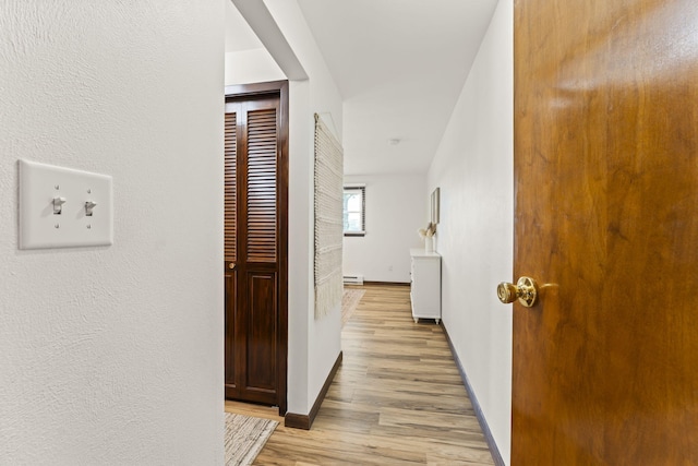 5899 N Springcreek Stringtown Rd, Piqua, OH 45356 - hall with a baseboard radiator and light wood-style flooring