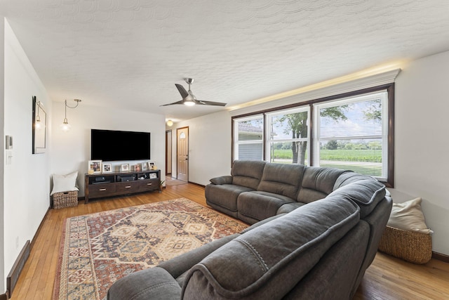 5899 N Springcreek Stringtown Rd, Piqua, OH 45356 - living room featuring hardwood / wood-style floors, ceiling fan, and a textured ceiling