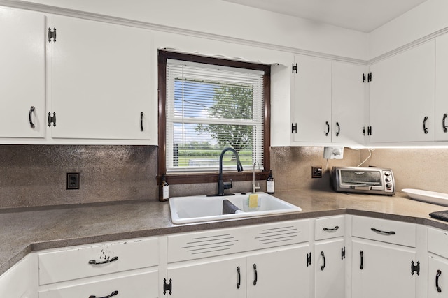 5899 N Springcreek Stringtown Rd, Piqua, OH 45356 - kitchen featuring white cabinetry and tasteful backsplash