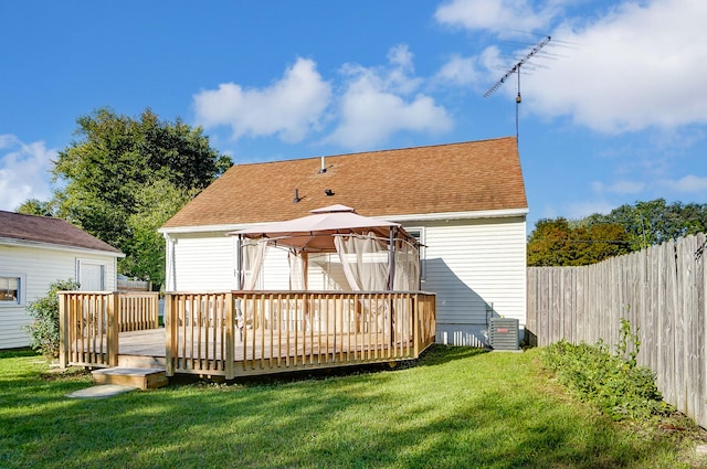 back of property with a yard, a gazebo, and a deck