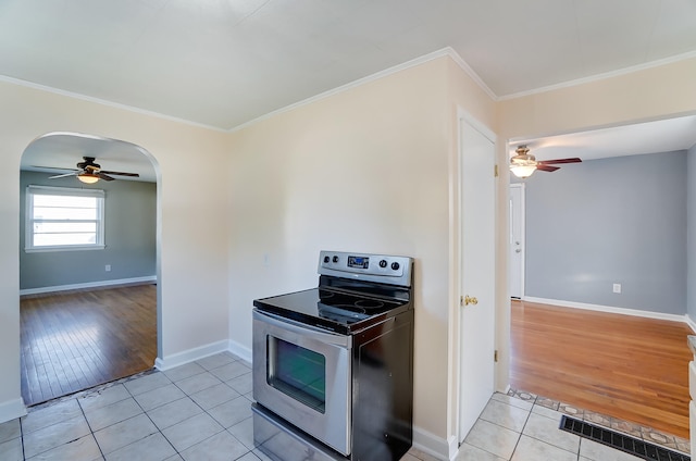 kitchen with light tile patterned floors, stainless steel electric stove, ornamental molding, and ceiling fan