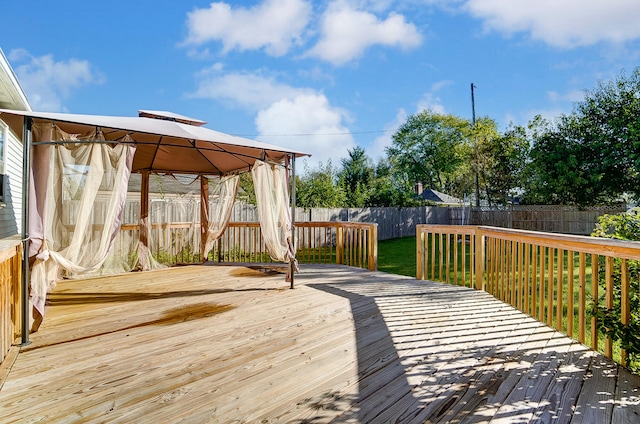 wooden terrace featuring a gazebo