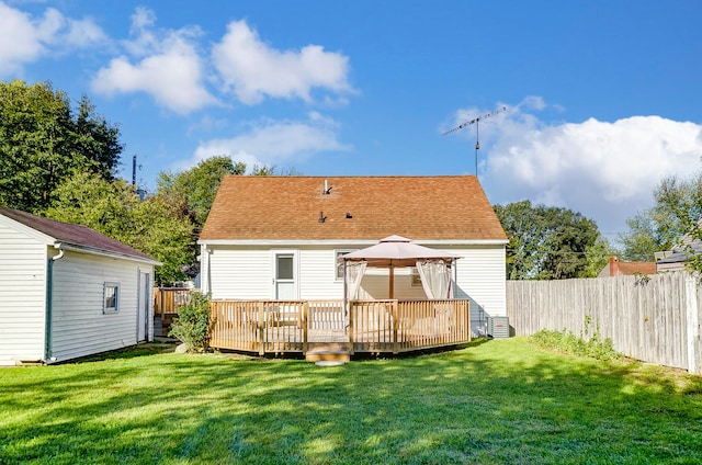 back of property with a yard, a gazebo, and a deck