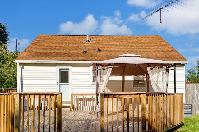 back of property with a gazebo and a deck