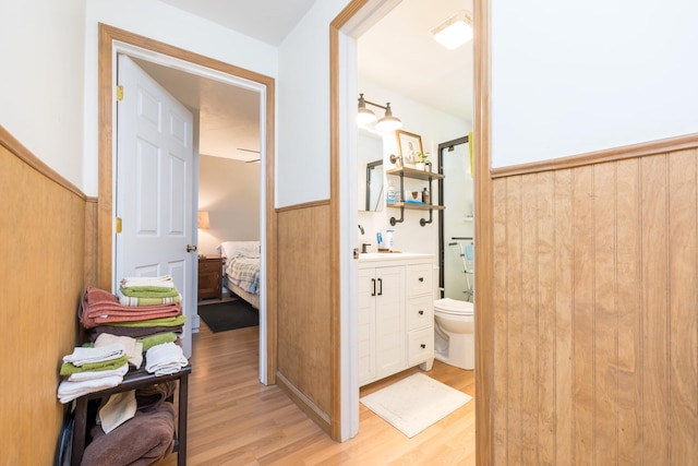 13730 Seminole Path, Lakeview, OH 43331 - bathroom with wood finished floors, vanity, a shower with shower door, a wainscoted wall, and ensuite bathroom