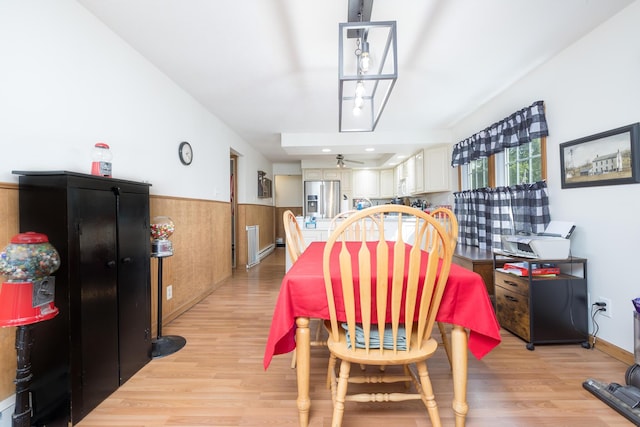 13730 Seminole Path, Lakeview, OH 43331 - dining room featuring light wood-style flooring, wainscoting, and ceiling fan