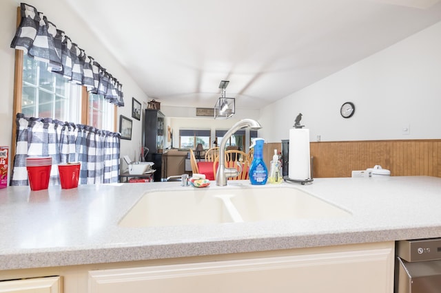 13730 Seminole Path, Lakeview, OH 43331 - kitchen with lofted ceiling, stainless steel dishwasher, and light countertops