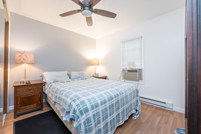 13730 Seminole Path, Lakeview, OH 43331 - bedroom with a baseboard heating unit, cooling unit, light wood-style flooring, and ceiling fan