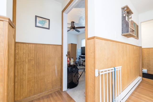 13730 Seminole Path, Lakeview, OH 43331 - hall with a wainscoted wall, wood finished floors, a baseboard radiator, wood walls, and a baseboard heating unit