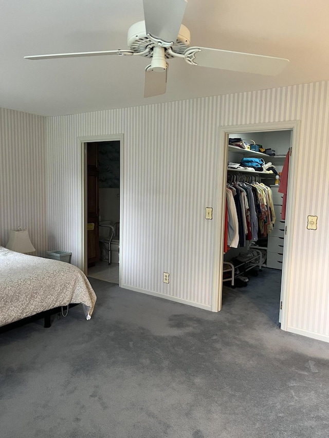 carpeted bedroom with a closet, wallpapered walls, and a spacious closet