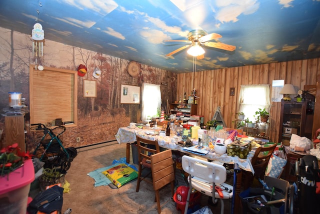 misc room with ceiling fan, a baseboard radiator, a workshop area, and a wealth of natural light