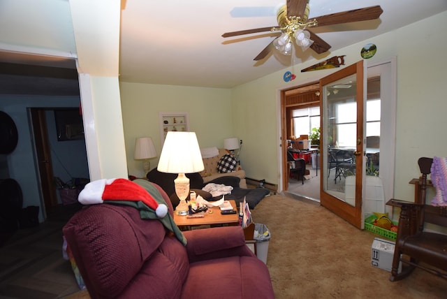 carpeted living room with ceiling fan and french doors