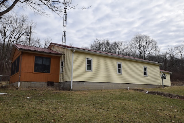 view of property exterior with a yard