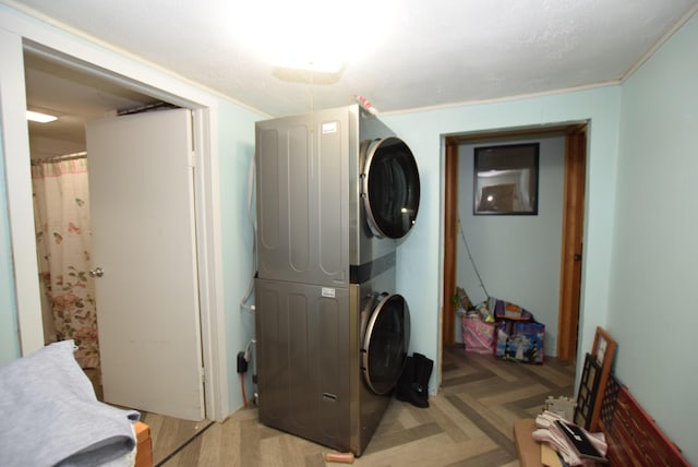 washroom featuring stacked washer and clothes dryer