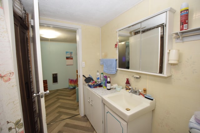 bathroom featuring vanity and parquet flooring