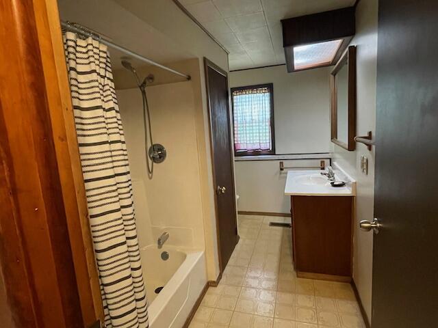 9770 Agerter Rd, Spencerville, OH 45887 - full bath with vanity, shower / bath combo with shower curtain, and tile patterned floors