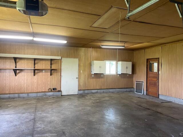 9770 Agerter Rd, Spencerville, OH 45887 - garage featuring a garage door opener and wooden walls