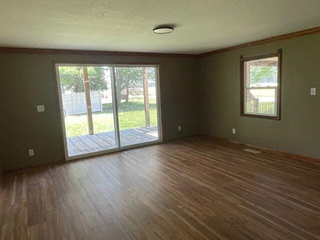 9770 Agerter Rd, Spencerville, OH 45887 - spare room featuring wood finished floors, plenty of natural light, crown molding, and a textured ceiling