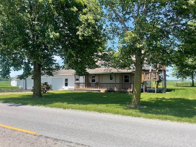 9770 Agerter Rd, Spencerville, OH 45887 - ranch-style house featuring a front yard, a garage, and a wooden deck