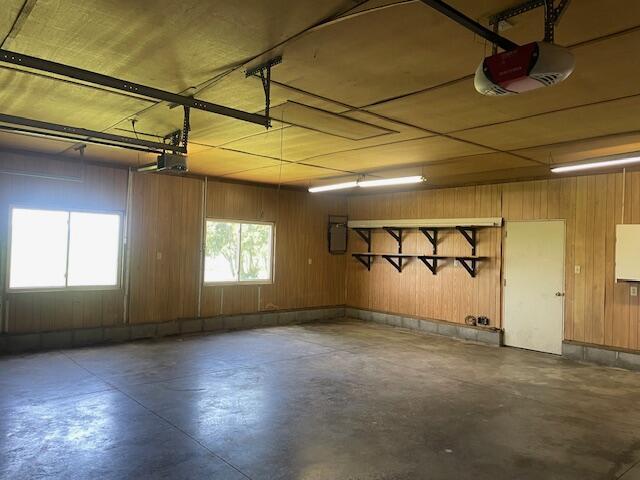 9770 Agerter Rd, Spencerville, OH 45887 - garage featuring a garage door opener and wood walls