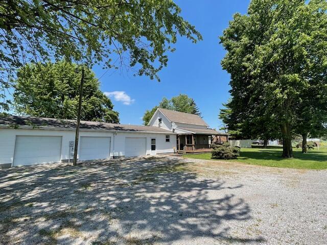 9770 Agerter Rd, Spencerville, OH 45887 - view of front of property with a garage and covered porch