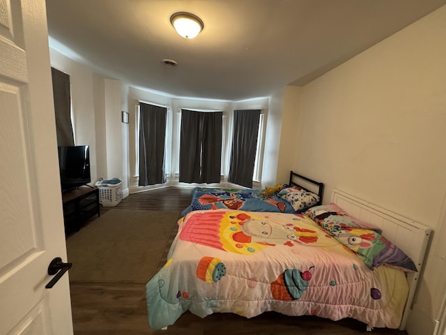 bedroom featuring dark wood-type flooring and visible vents