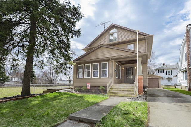 view of front of home with a front yard, an outbuilding, fence, and a garage