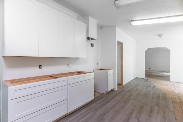 13253 State Route 720, Lakeview, OH 43331 - kitchen with white cabinetry, light wood-style flooring, and arched walkways