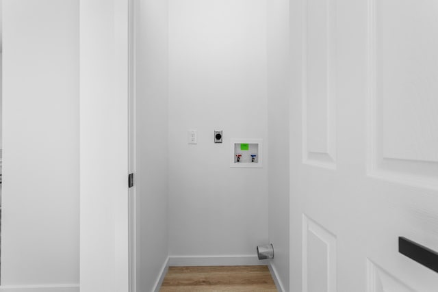 washroom with washer hookup, light wood-style floors, baseboards, hookup for an electric dryer, and laundry area