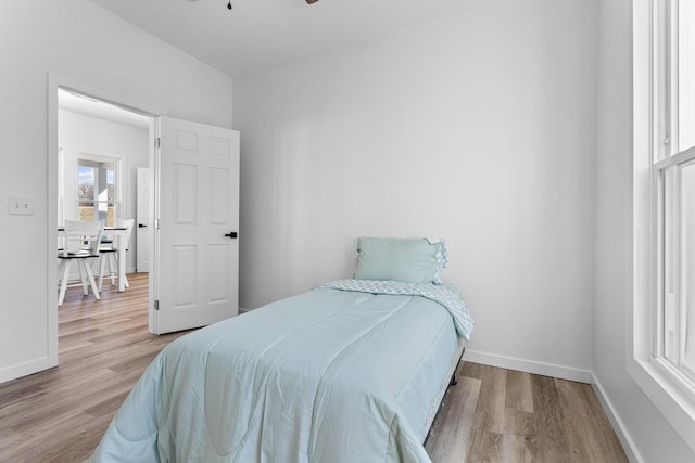 bedroom featuring baseboards and wood finished floors